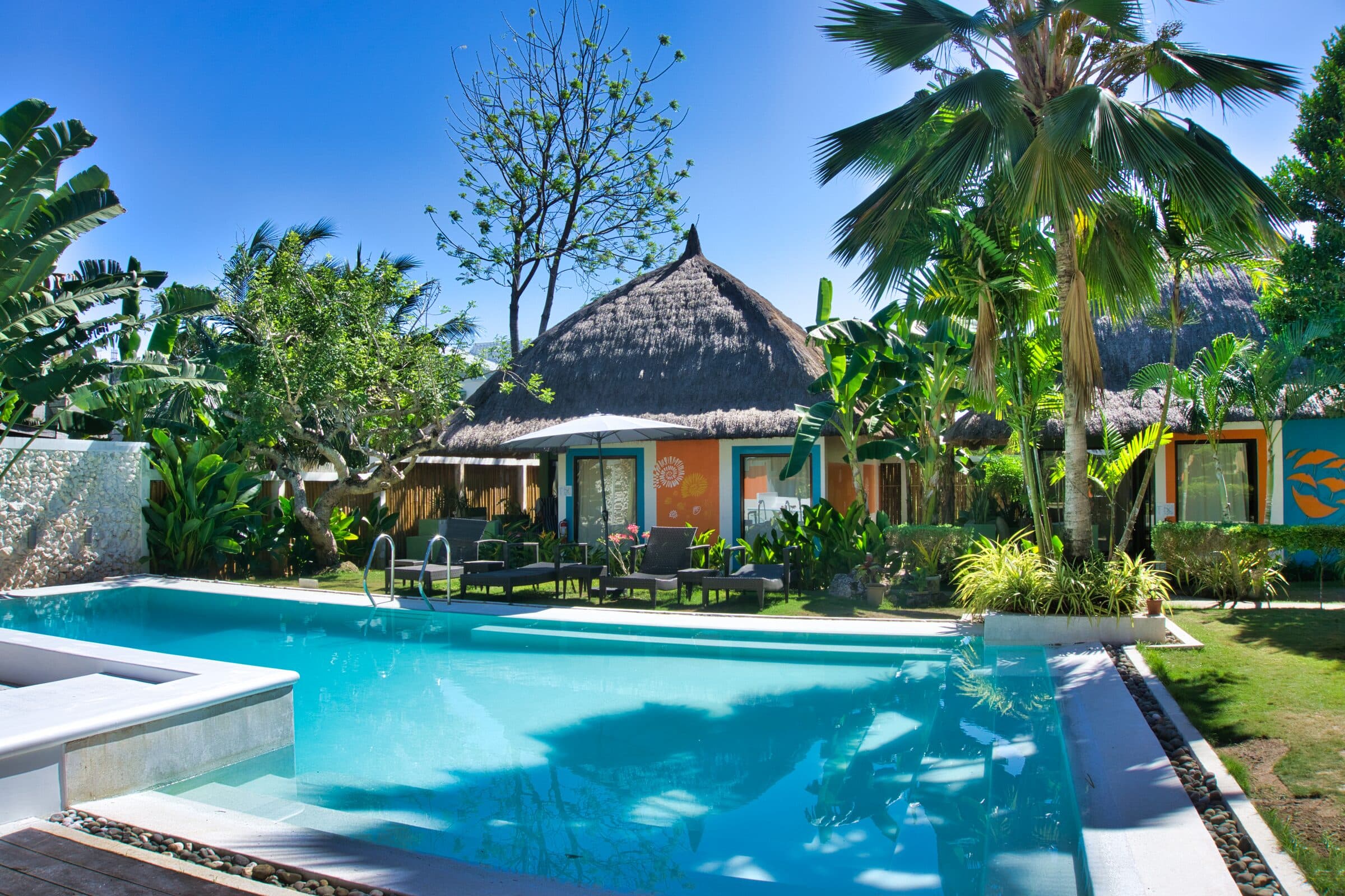 Resort swimming pool framed by tropical gardens