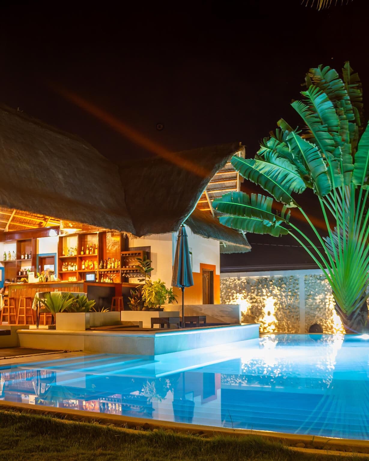 Pool and bar lit up at night